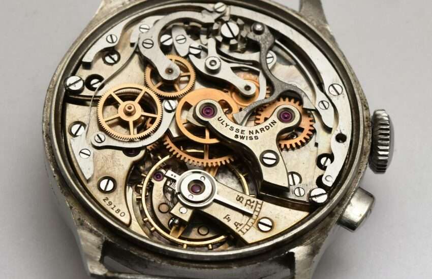 Detailed view of an intricate vintage watch mechanism with visible gears and components.